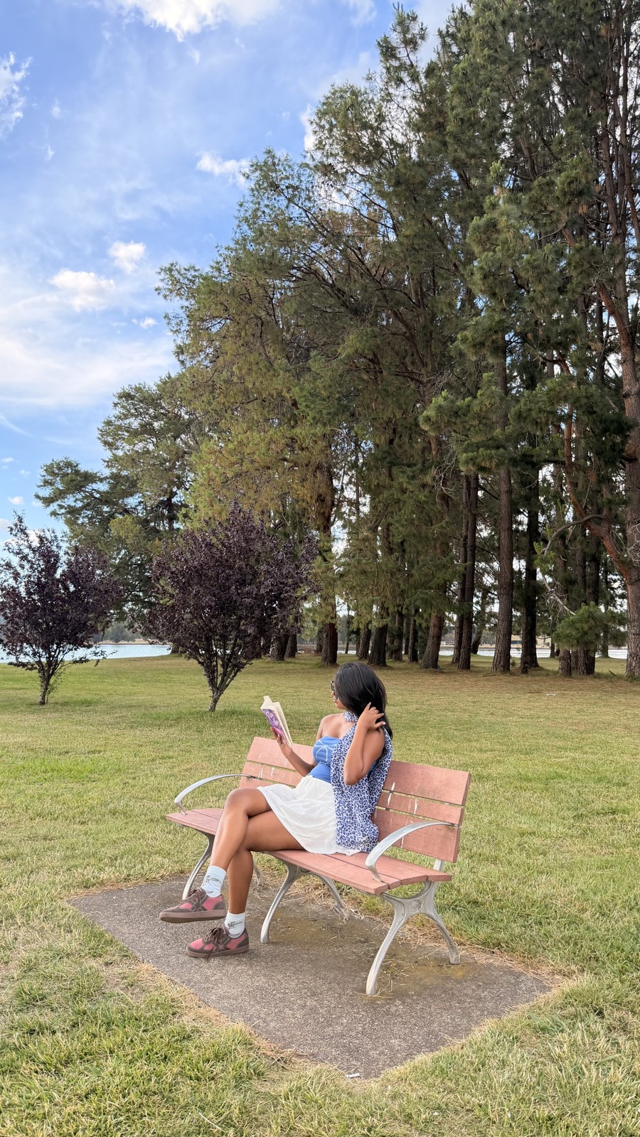 Pink CHRN sneakers worn while relaxing on a park bench